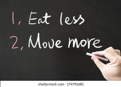 Eat Less And Move More Words Written On The Blackboard Using Chalk