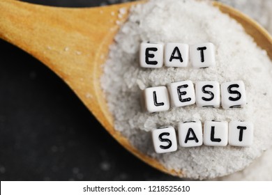 Eat Less Salt In Order To Reduce Blood Pressure Or Hypertension Risk With Sprinkled Salt On Dark Background
