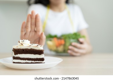 eat less sugar for health, women avoid to eat chocolate cake and sweets during sugar diet session for lose weight
