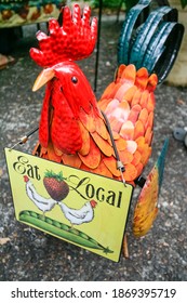 Eat Local sign on rooster sculpture