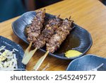 Eat lunch at a famous standing izakaya pub in Yokohama.
They serve delicious  skewers of grilled tripe and raw meat.
Yokohama City, Kanagawa 2024.
