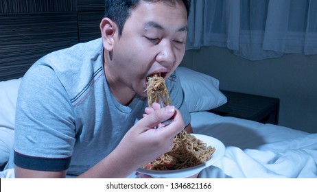 Eat At Midnight, Bad Eating Habit, Late Night Dinner On Bed, Asian Man Eat Noodle