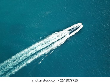 Eat My Wake. High Angle Shot Of A Boat Speeding Through The Water.