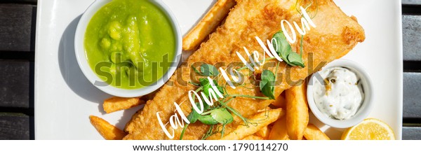 Eat Out to Help Out phrase. Traditional\
English Food such as Fish and Chips with green mushy peas served in\
the Pub or Restaurant