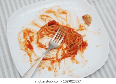 Eated Spaghetti Pasta With Tomatoe Sauce. Dirty Dishes. Sauce Smeared On A Plate.