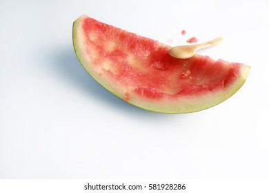 Eaten slice of watermelon from japan with wooden spoon isolated on white