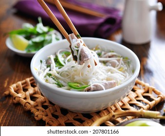 Eating A Bowl Of Pho With Noodles And Beef