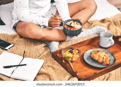 Eating breakfast, person or notebook in bed for hotel, hospitality and accommodation in morning. Tea, tray or hands with fruit salad in lodge with satisfaction, coffee and food on vacation or holiday - Powered by Shutterstock