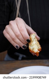 Eating Cheese Balls At The Restaurant. Closeup View Of A Caucasian Woman's Hand, Holding A Potato And Mozzarella Croquette Dipped In Sweet Chili Sauce.