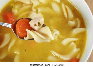 Eating Chicken Noodle Soup With Spoon