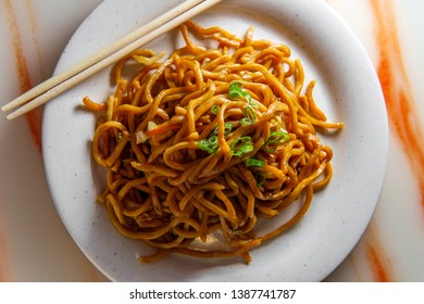 Eating Chinese Vegetable Lo Mein Noodles With Chopsticks