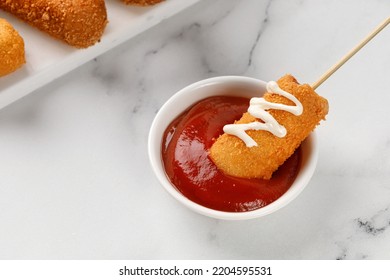 Eating Corn Dog With Ketchup And Mayo On White Marble Background. Traditional American Street Food. Fried Sausage On A Stick. Сorn Dog, Corndog.