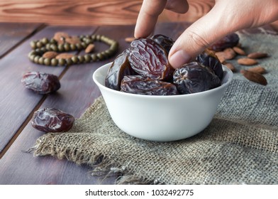 Eating Dried Dates. Almonds On Wooden Table. Traditional Arabic Food. Ramadan Event. 