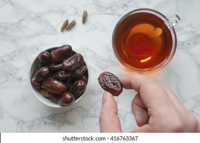 Eating Dried Dates. Cup Of Tea On Marble Table. Traditional Arabic Food. Top View