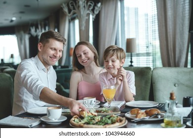 Eating Family At A Dinner In A Restaurant