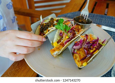 Eating Fish Tacos With Black Beans