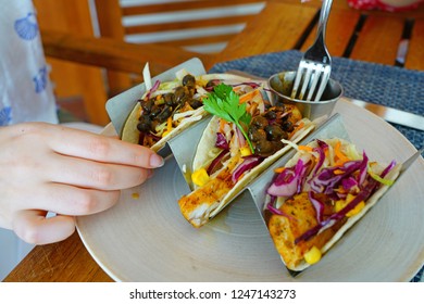 Eating Fish Tacos With Black Beans