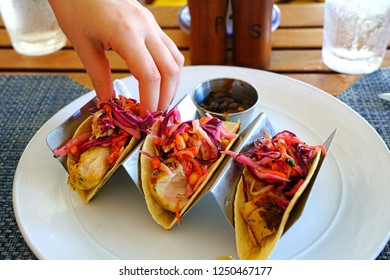 Eating Fish Tacos With Black Beans