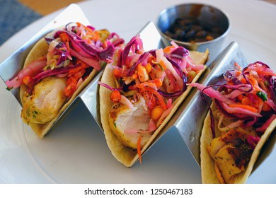 Eating Fish Tacos With Black Beans