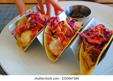 Eating Fish Tacos With Black Beans