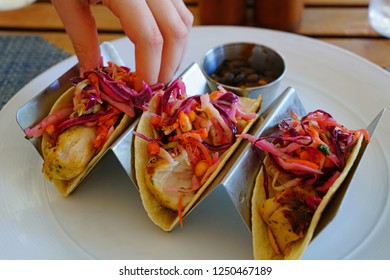 Eating Fish Tacos With Black Beans