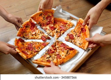 Eating Food. Close-up Of People Hands Taking Slices Of Pepperoni Pizza. Group Of Friends Sharing Pizza Together. Fast Food, Friendship, Leisure, Lifestyle. - Powered by Shutterstock