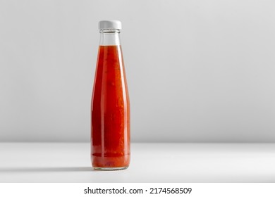 Eating, Food And Culinary Concept - Close Up Of Sour Sweet Asian Sauce In Glass Bottle On Table