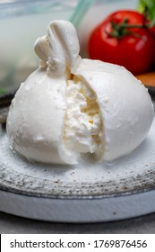 Eating Of Fresh Handmade Soft Italian Cheese From Puglia, White Balls Of Burrata Or Burratina Cheese Made From Mozzarella And Cream Filling Close Up