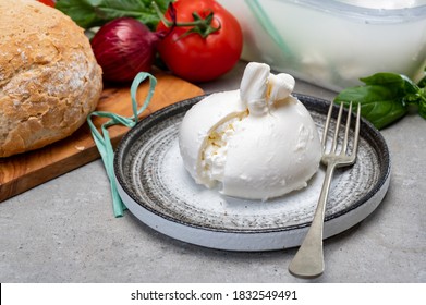 Eating Of Fresh Handmade Soft Italian Cheese From Puglia, White Balls Of Burrata Or Burratina Cheese Made From Mozzarella And Cream Filling Close Up