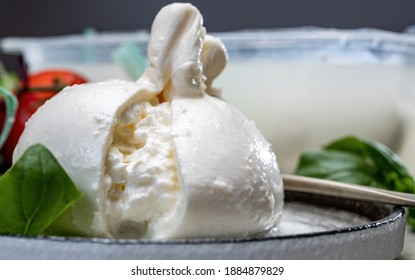 Eating Of Fresh Handmade Soft Italian Cheese From Puglia, White Balls Of Burrata Or Burratina Cheese Made From Mozzarella And Cream Filling Close Up