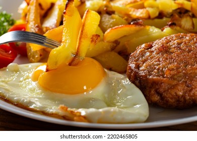 Eating Fries With Fried Egg - Close Up View