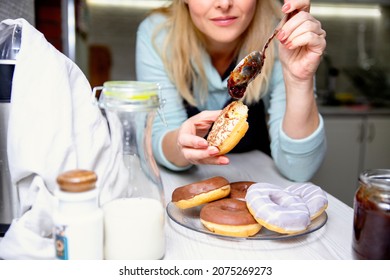 Eating glazed Donuts with jelly and milk. Millennial Woman enjoying comfort sweet pastry food - Powered by Shutterstock