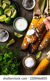 Eating Grilled Corn Cobs With Fresh Herbs,lime,beer And Salsa.