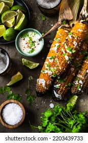 Eating Grilled Corn Cobs With Fresh Herbs,lime,beer And Salsa.