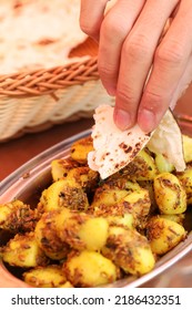 Eating Indian Food By Using Hand Picking Up Naan