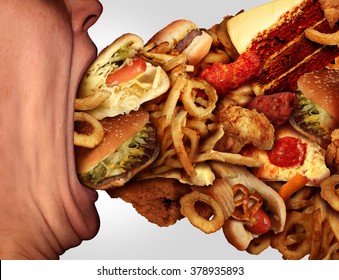 Eating junk food nutrition and dietary health problem concept as a person with a big wide open mouth feasting on an excessive huge group of unhealthy fast food and snacks.