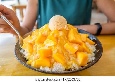 eating mango shaved ice with colorful dessert, famous Taiwanese snacks at Taiwan