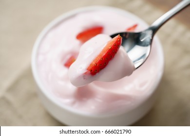 Eating Organic Strawberry Yogurt With Spoon, Shallow Focus