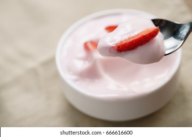 Eating Organic Strawberry Yogurt With Spoon, Shallow Focus