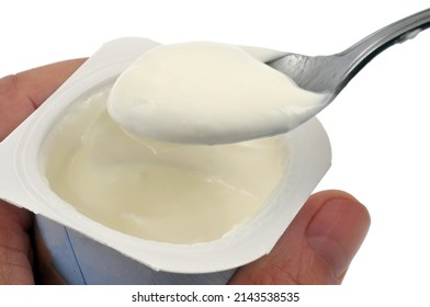 Eating Plain Yogurt With A Spoon Close-up On A White Background 