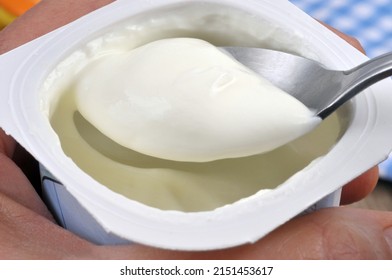 Eating Plain Yogurt With A Spoon Close-up 