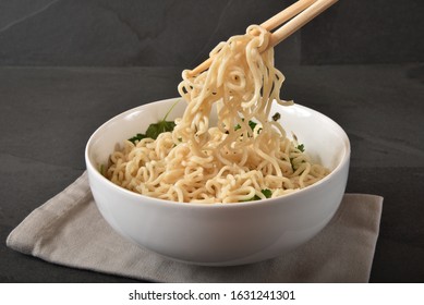 Eating Raman Noodles From A Bowl With Chop Sticks