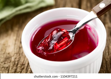 Eating Red Jelly Or Jello, Spoonful Of Jelly On The Top (Selective Focus, Focus In The Middle Of The Image)