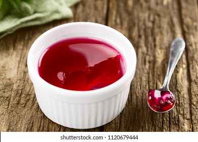 Eating Red Jelly Or Jello, Spoonful Of Jelly On The Side (Selective Focus, Focus In The Middle Of The Image)