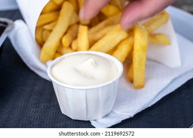 Eating of street or take away food fresh baked french fried potatoes chips in paper cone - Powered by Shutterstock