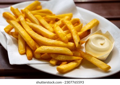 Eating of street or take away food fresh baked french fried potatoes chips with Belgian mayonnaise, close up - Powered by Shutterstock