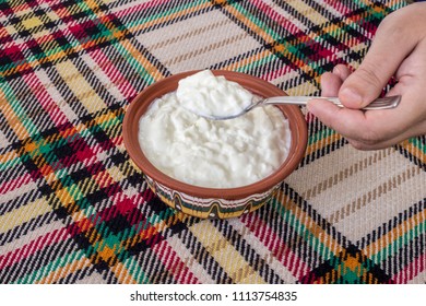 Eating a traditional bulgarian yogurt from a bowl