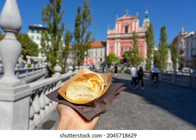 eating traditional slovenian strukelj roll in Ljubljana .