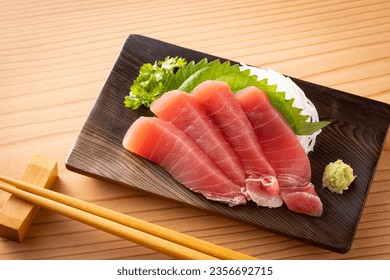 Eating tuna sashimi at a Japanese izakaya