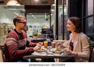 Eating, Vegetarian Food And People Concept - Happy Couple Or Friends Having Dinner At Vegan Restaurant